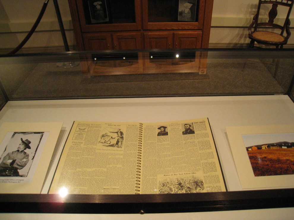 Center: reproduction newspaper with stories about the war. Left: Photo of George Armstrong Custer