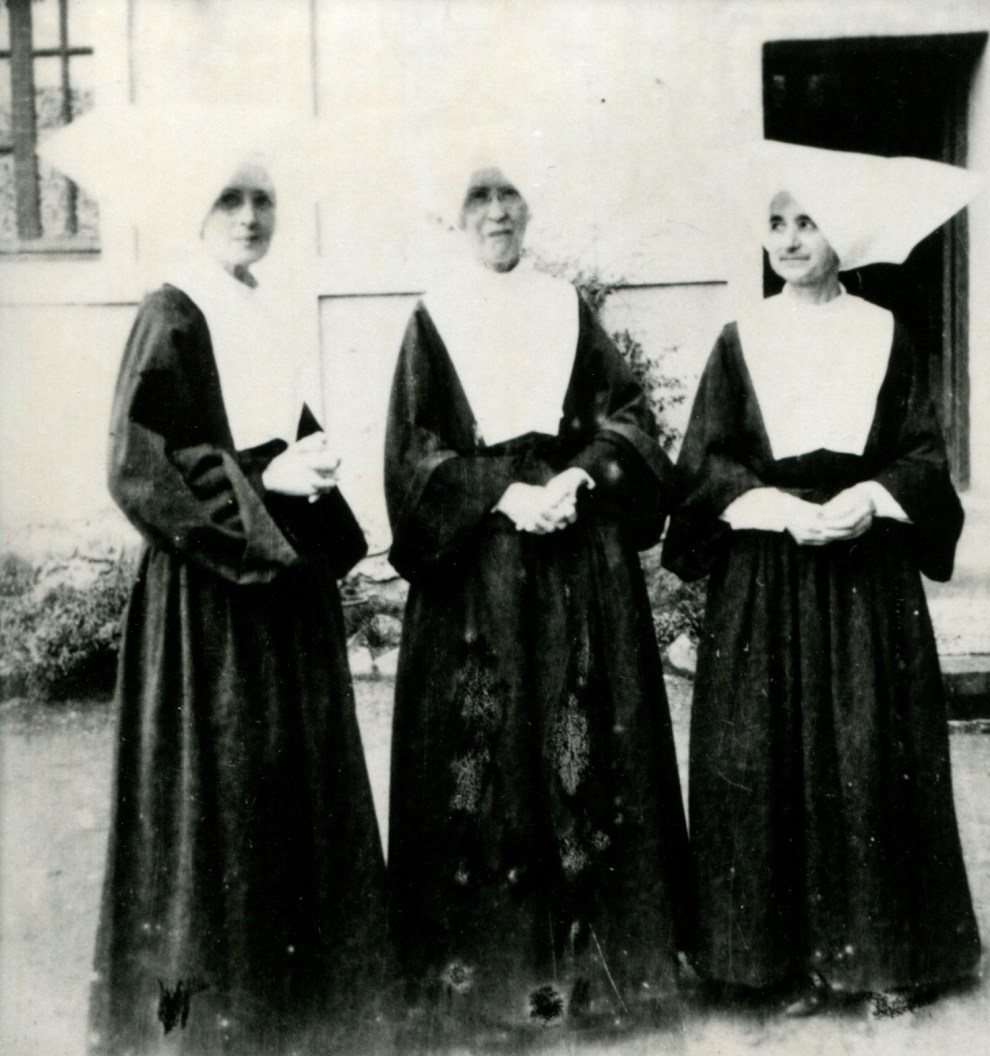 Sisters Clara Groell, Eugenia Biggs, and Catherine O’Neill outside barracks, Aug. 1945. These three sisters were missioned in China and ended up serving as U.S. Army nurses in the Pacific theater of World War II.
